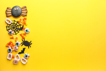 Halloween composition with tasty treats on color background