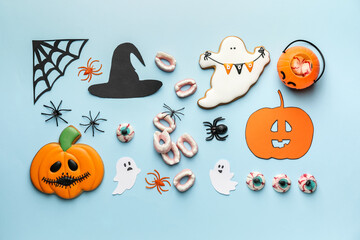 Halloween composition with tasty treats on color background