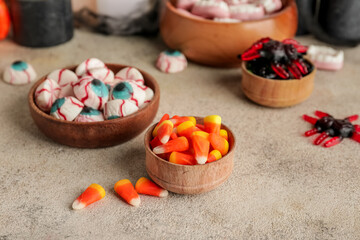 Tasty treats for Halloween on grey background