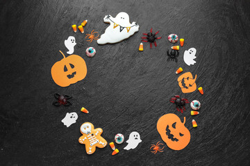 Halloween composition with tasty treats on dark background