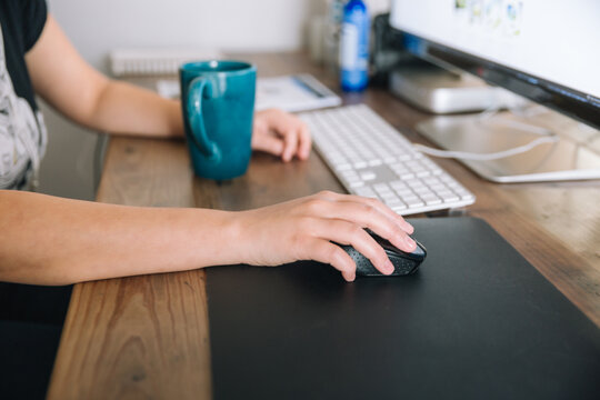 Person sitting at desk with computer.