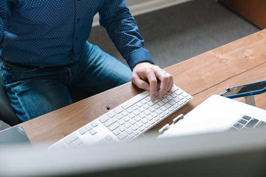 Person sitting at desk with computer.