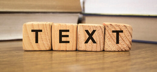 Text words on wooden blocks with Books on blurred backround