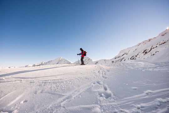 Skier standing on snow covered mountain plateau