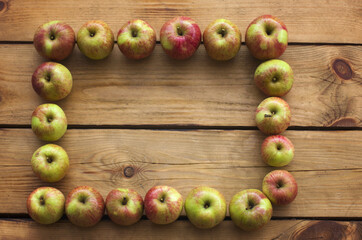 Apple frame on wooden background. Fresh organic apples on the rustic wodeen background.  Love Concept. The autumn concept