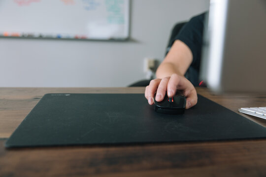 Person sitting at desk with computer.