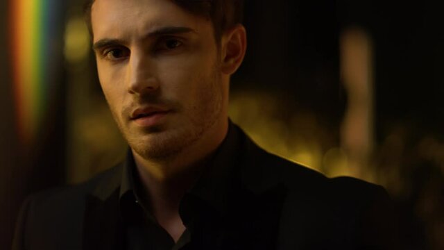 Ambitious top manager straightening jacket. Confident man throwing head back.