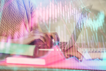 Double exposure of woman hands typing on computer and forex chart hologram drawing. Stock market analysis concept.