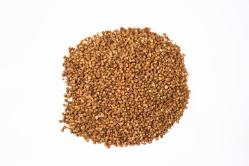 Buckwheat on a white background. Choice buckwheat. Groats on a white table.