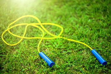 Jump rope on a green summer background