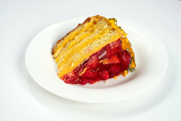 A piece of cake with strawberries and raspberries on a white plate, isolate
