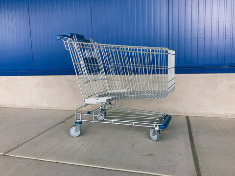 Shopping cart against blue wall