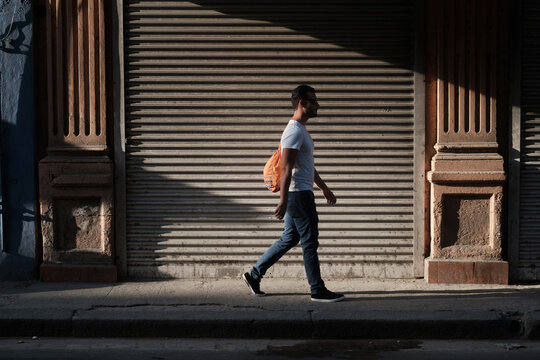 Young Man Walking Down The Street