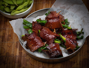 Vegan seitan negimaki on parchment paper