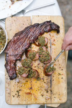 Grilled steack and sausages with chimichurri sauce