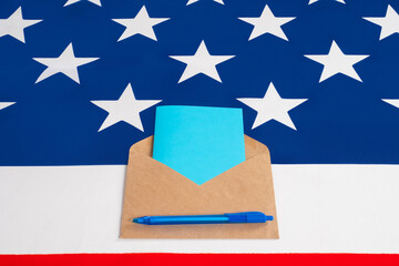Voting for president by postal in America. Envelope with a colored bulletin on US flag. Blue ballot paper. Concept - voting through postal service in United States of America. President election US