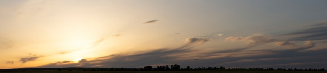 Storm clouds against a blue sky. Mystical sunset. Panorama. Tragic gloomy sky. Fantastic skies on...
