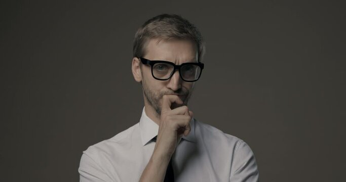 Pensive businessman feeling doubtful