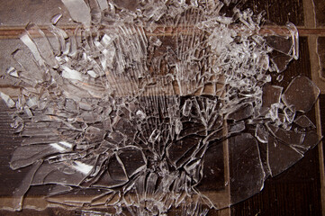 broken glass lies on the brown floor. beautiful pattern