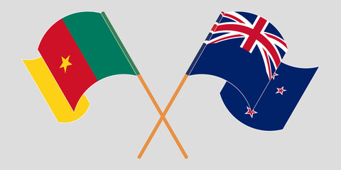 Crossed and waving flags of Cameroon and New Zealand