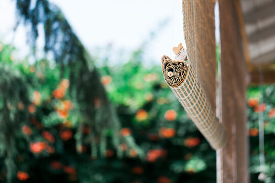 Bamboo blinds in front of patio in garden, detail