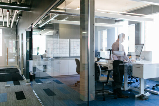 Man Working at Standing Desk in Modern Office