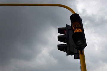 Yellow Traffic light with grey and rainy day at background. Traffic concept