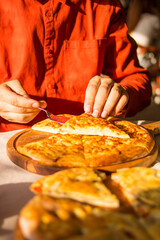 Khachapuri on a wooden board with yellow leaves