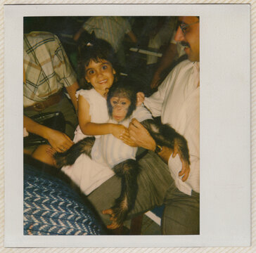 Old scanned photo of girl with a chimpanzee