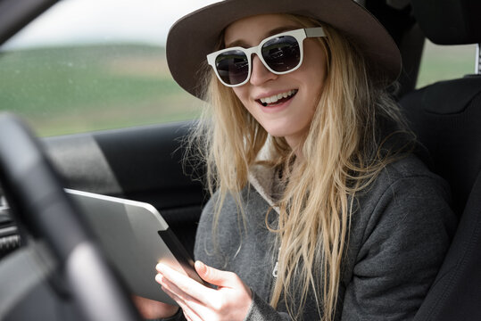 Woman with tablet in the car