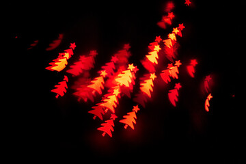 Bokeh in the shape of a Christmas tree. New year background. Selective focus