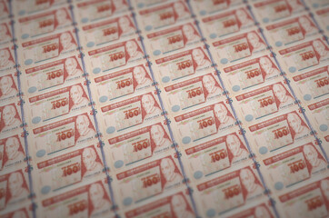 100 Guatemalan quetzales bills printed in illegal money production conveyor. Collage of many fake...