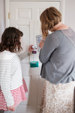 Autistic child looking at visual cards with her therapist