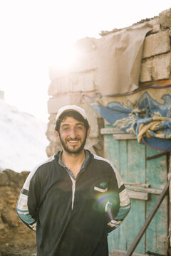 portrait of a smiling kurdish farmer in front of his barn