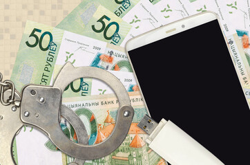 50 Belorussian rubles bills and smartphone with police handcuffs. Concept of hackers phishing...