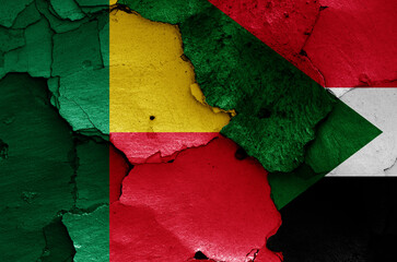 flags of Benin and Sudan painted on cracked wall