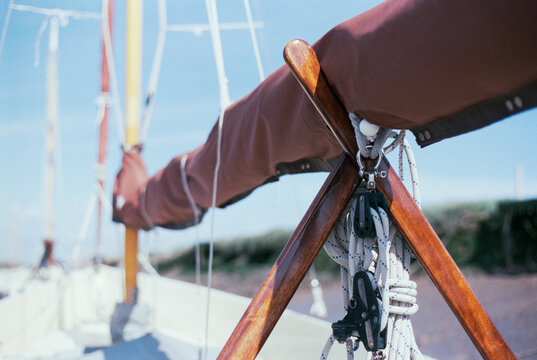 Boom and main sail of a sailing boat secured away. Morston Quay,
