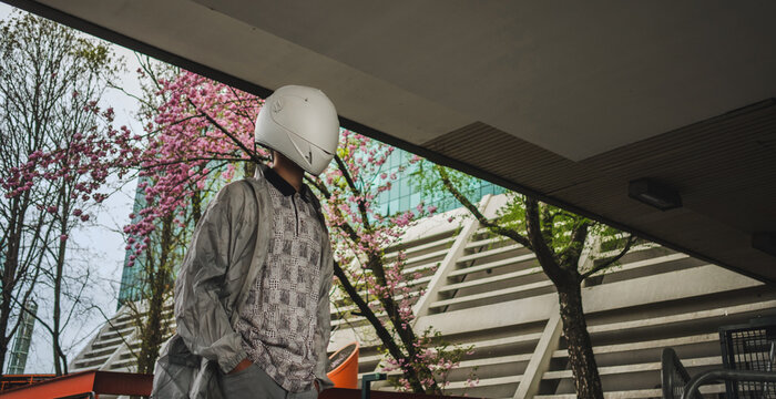 Abstract scene with person with white helmet/mask and silver jacket i.