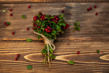 Lingonberry bouquet on a wooden surface. Berries. Raw food diet.