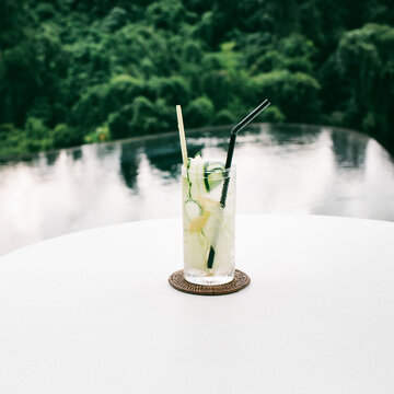 Closeup of Tropical Cucumber Cocktail in Longdrink Glass Standing on White Table
