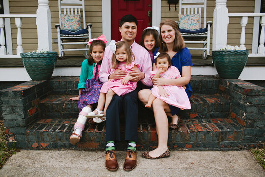Family sitting on front steps