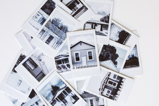 Pile of polaroid photographs of various houses