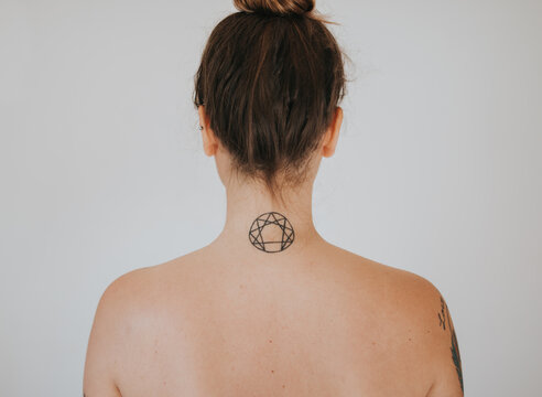 Back of woman with tattoo on the neck