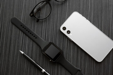 Flat lay composition with stylish smart watch on black table