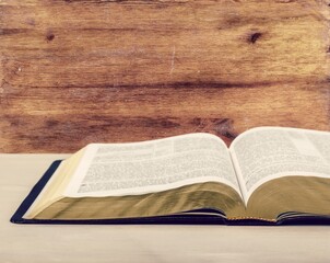 Holy Bible book on a wooden desk