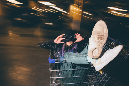Young woman in a supermarket trolley