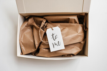 open gift box with a handwritten tag ""to me""