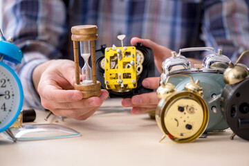 Young male watchmaker working in the workshop