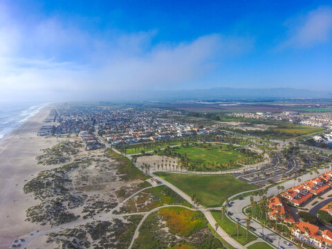 a stunning aerial shot of the beach front homes and city of Oxnard surrounding Oxnard State Beach Park in Oxnard California USA