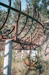Old abandoned wooden bobsleigh track in summer by daylight